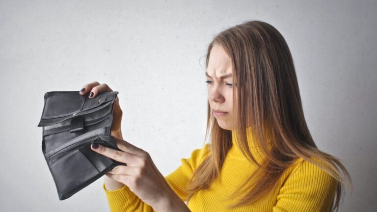 woman holding black wallet