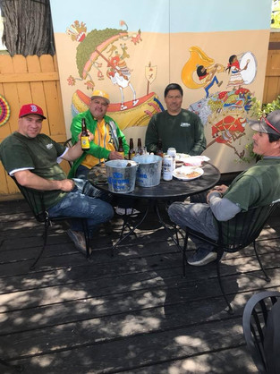 Men outside drinking beer on a sunny day.